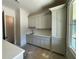 Butler's pantry featuring custom cabinets, sink and windows at 4435 Pebble Rock Dr, Cumming, GA 30041