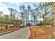 Private driveway leading to a lakefront property, surrounded by mature trees and beautiful scenery at 4435 Pebble Rock Dr, Cumming, GA 30041