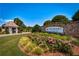 Landscaped entrance to a community with stone signage and flowering bushes, offering a welcoming feel at 4435 Pebble Rock Dr, Cumming, GA 30041