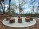 Community fire pit area with stone seating, perfect for gathering and enjoying the natural surroundings at 4435 Pebble Rock Dr, Cumming, GA 30041