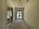 Grand foyer with black metal entry door, chandelier, and open layout at 4435 Pebble Rock Dr, Cumming, GA 30041