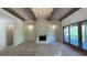 Bright living room with wood beams, stone fireplace, and sliding glass doors at 4435 Pebble Rock Dr, Cumming, GA 30041