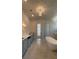 Luxury main bathroom with a soaking tub, custom cabinets, and marble floors at 4435 Pebble Rock Dr, Cumming, GA 30041
