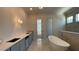 Luxury main bathroom with a soaking tub, custom cabinets, and marble floors at 4435 Pebble Rock Dr, Cumming, GA 30041