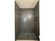 Modern shower with sleek black tile and multiple showerheads at 4435 Pebble Rock Dr, Cumming, GA 30041