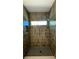 Shower featuring neutral tile and a built-in niche at 4435 Pebble Rock Dr, Cumming, GA 30041