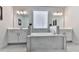 Bright bathroom with large mirrors, double sinks, a soaking tub, and neutral tile at 449 Carmichael Cir, Canton, GA 30115
