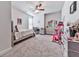 Bright bedroom with ceiling fan, desk, drawers, and a bed at 449 Carmichael Cir, Canton, GA 30115