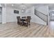 Well-lit dining room features wainscoting, a modern chandelier, and staircase access at 449 Carmichael Cir, Canton, GA 30115