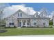 Charming single-story home showcasing a brick facade, dormer windows and meticulously maintained front lawn at 449 Carmichael Cir, Canton, GA 30115