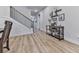 Open hallway featuring wood floors, stairs with dark banisters and a console table with decorative items at 449 Carmichael Cir, Canton, GA 30115