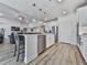 A kitchen with stainless steel appliances, a large island, and seamless transition to the living area at 449 Carmichael Cir, Canton, GA 30115