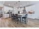 Spacious kitchen features white cabinets, stainless steel appliances, and a large island with seating for four at 449 Carmichael Cir, Canton, GA 30115