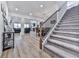 Spacious living room with a fireplace, hardwood floors, and staircase access to the second floor at 449 Carmichael Cir, Canton, GA 30115