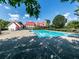 A beautifully kept community pool with clear blue water, surrounded by lush trees and plenty of space for lounging at 449 Carmichael Cir, Canton, GA 30115