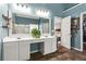 Bathroom with white vanity, framed mirror, and access to shower and walk-in closet at 904 Beaumont Ct, Canton, GA 30114