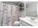 Bathroom featuring tiled shower with curtain and single vanity with storage at 904 Beaumont Ct, Canton, GA 30114