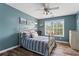 Comfortable bedroom featuring wood flooring, blue accent wall, and a bright window at 904 Beaumont Ct, Canton, GA 30114