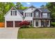 Charming two-story home with a manicured lawn, inviting front porch, and a two-car garage at 904 Beaumont Ct, Canton, GA 30114