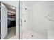Modern bathroom features a glass enclosed shower with marble tile and a peek into the walk-in closet at 1388 La France Ne St, Atlanta, GA 30307