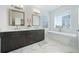 Elegant bathroom with a double vanity, large soaking tub, and modern fixtures at 1388 La France Ne St, Atlanta, GA 30307