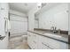Modern bathroom with vanity, sink, mirror and shower with white and gray tiling at 1388 La France Ne St, Atlanta, GA 30307