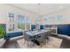 This dining room features a modern chandelier, large windows, and stylish furniture at 1388 La France Ne St, Atlanta, GA 30307