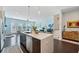 Open kitchen with modern appliances, a large island with seating, and access to the living room at 1388 La France Ne St, Atlanta, GA 30307