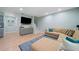 Comfortable living room features a large TV, and a cozy sectional sofa atop a stylish blue patterned rug at 1388 La France Ne St, Atlanta, GA 30307