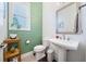 Modern powder room featuring green shiplap walls, a pedestal sink, and stylish fixtures at 1388 La France Ne St, Atlanta, GA 30307