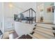Inviting staircase with carpeted steps, leading to an open dining area with modern railing at 1388 La France Ne St, Atlanta, GA 30307