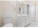 Bright bathroom featuring a large vanity with gold hardware and spacious linen closet at 488 Takely Dr, Lawrenceville, GA 30046