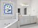 Bright bathroom featuring double vanity, stained glass window, and a soaking tub at 488 Takely Dr, Lawrenceville, GA 30046