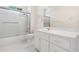 Bright bathroom with a shower-tub combination and large vanity with gold hardware at 488 Takely Dr, Lawrenceville, GA 30046