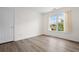 Bright bedroom with hardwood floors, a window with curtains, and a white door at 488 Takely Dr, Lawrenceville, GA 30046
