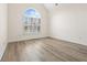 Empty bedroom featuring a large window and luxury vinyl plank flooring at 488 Takely Dr, Lawrenceville, GA 30046