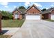 Charming brick home featuring a well-manicured lawn, two-car garage, and arched entryway at 488 Takely Dr, Lawrenceville, GA 30046