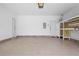 Spacious garage with a white door and an overhead garage door at 488 Takely Dr, Lawrenceville, GA 30046
