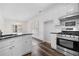 Kitchen featuring stainless steel appliances, white cabinets and granite countertops at 488 Takely Dr, Lawrenceville, GA 30046