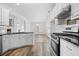 Bright kitchen with white cabinets, stainless steel appliances, and breakfast bar at 488 Takely Dr, Lawrenceville, GA 30046