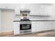 Kitchen featuring stainless steel appliances, white cabinets and subway tile backsplash at 488 Takely Dr, Lawrenceville, GA 30046
