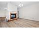 Open-concept living room featuring a brick fireplace and modern flooring at 488 Takely Dr, Lawrenceville, GA 30046