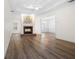 Living room featuring a fireplace with a brick hearth and hardwood floors at 488 Takely Dr, Lawrenceville, GA 30046