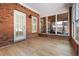 Covered patio with brick accents and a view of the backyard through large windows at 488 Takely Dr, Lawrenceville, GA 30046