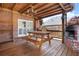 Covered patio featuring an outdoor fireplace and wood table with bench seating at 488 Takely Dr, Lawrenceville, GA 30046