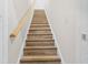 View of carpeted staircase with wood handrail leading to the upper level, providing a classic touch at 488 Takely Dr, Lawrenceville, GA 30046