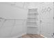 Well-organized walk-in closet features bright lighting and shelving to maximize storage space at 488 Takely Dr, Lawrenceville, GA 30046