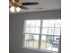 Large window views a neighborhood through this bedroom at 5815 Mountain Top Pl, Cumming, GA 30041