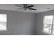 Bedroom features neutral walls, a ceiling fan, and plenty of natural light at 5815 Mountain Top Pl, Cumming, GA 30041