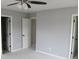 Bright bedroom with neutral walls, ceiling fan, and white doors at 5815 Mountain Top Pl, Cumming, GA 30041